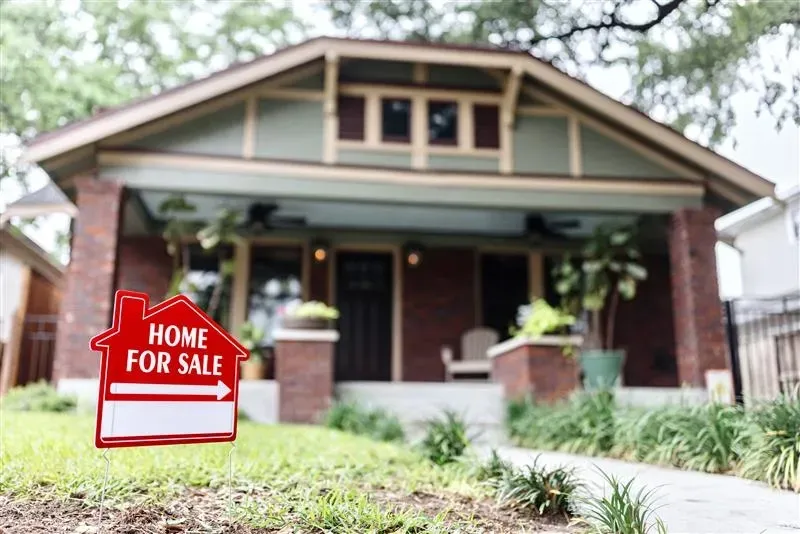 A 'For Sale' sign in front of a Dallas–Fort Worth home